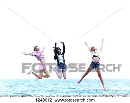 Three friends jumping in excitement on the beach View Large Photo Image Stock Image - Three friends jumping in excitement on the beach. Fotosearch
