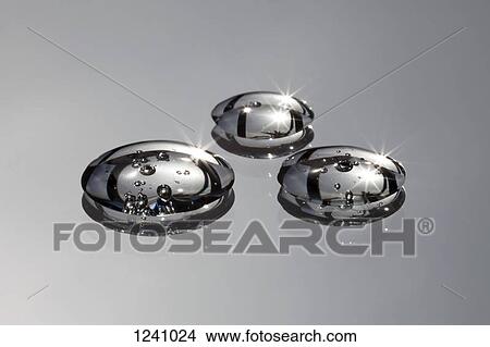 Three water drops with bubbles in them on a gray surface View Large Photo Image Picture - Three water drops with bubbles in them on a gray surface. Fotosearch