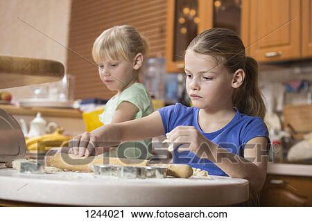 Two girls using baking dough View Large Photo Image Stock Image - Two girls using baking dough. Fotosearch