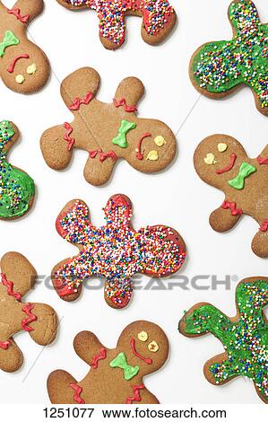 Stock Photo - Various decorated gingerbread men cookies arranged on a white background. Fotosearch
