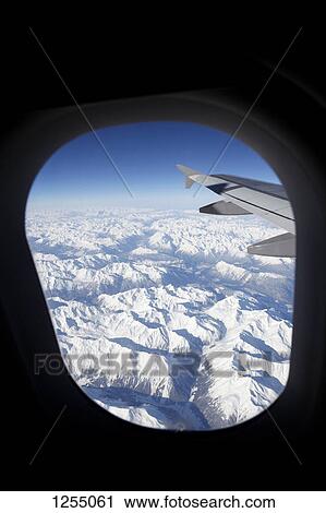 View of snowcapped Swiss Alps from an airplane View Large Photo Image Stock Image - View of snowcapped Swiss Alps from an airplane. Fotosearch