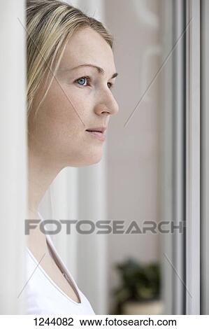 Stock Image - Woman looking into distance. Fotosearch