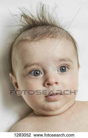 A baby boy looking away curiously View Large Photo Image Stock Image - A baby boy looking away curiously. Fotosearch