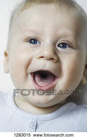 Stock Photography - A baby boy smiling and looking up. Fotosearch