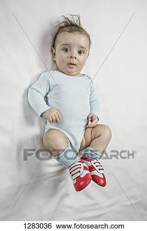 A baby boy wearing baby soccer shoes View Large Photo Image Stock Photograph - A baby boy wearing baby soccer shoes. Fotosearch