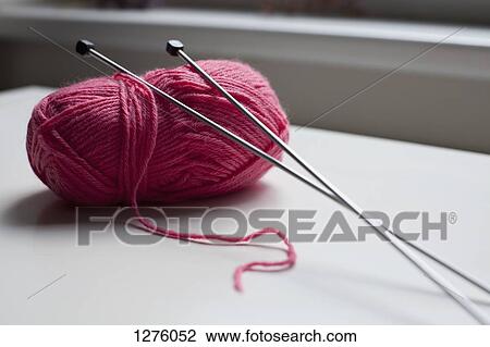 A ball of yarn with a pair of knitting needles leaning on it View Large Photo Image Stock Image - A ball of yarn with a pair of knitting needles leaning on it. Fotosearch