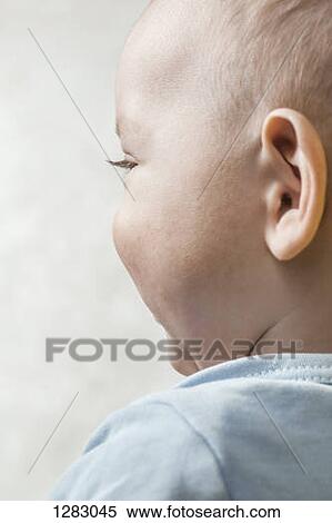 A carefree baby boy looking off camera View Large Photo Image Stock Photography - A carefree baby boy looking off camera. Fotosearch