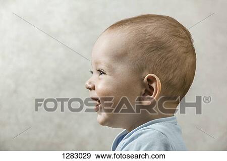 A carefree baby smiling and laughing while looking off camera View Large Photo Image Stock Photo - A carefree baby smiling and laughing while looking off camera. Fotosearch
