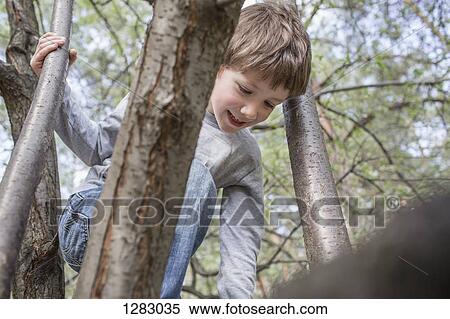 Stock Photography - A cheerful boy climbing a boy. Fotosearch