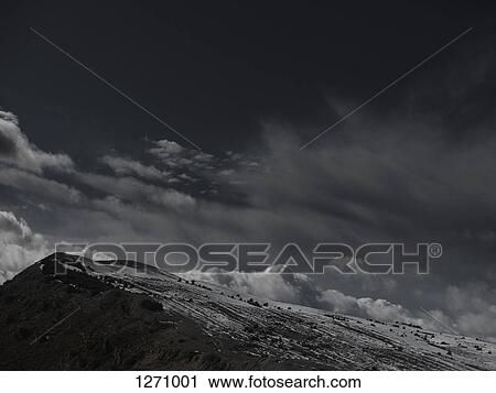 A dramatic cloudy sky above snow covered mountain View Large Photo Image Stock Image - A dramatic cloudy sky above snow covered mountain. Fotosearch