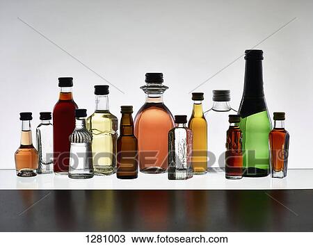 A grouping of various miniature bottles of alcohol without labels, back lit View Large Photo Image Stock Image - A grouping of various miniature bottles of alcohol without labels, back lit. Fotosearch