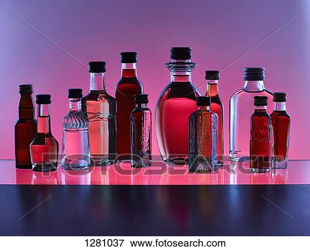 A grouping of various miniature bottles of alcohol without labels, back lit, colored background View Large Photo Image Stock Photo - A grouping of various miniature bottles of alcohol without labels, back lit, colored background. Fotosearch