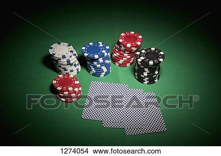 A hand of cards facedown, surrounded by stacks of gambling chips View Large Photo Image Picture - A hand of cards facedown, surrounded by stacks of gambling chips. Fotosearch