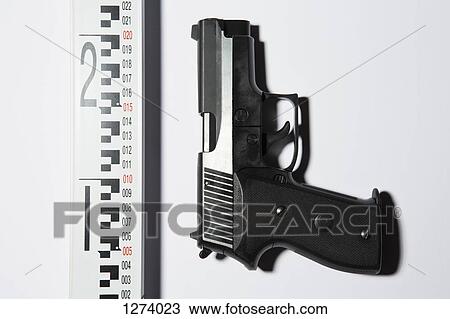 A handgun next to a ruler View Large Photo Image Stock Image - A handgun next to a ruler. Fotosearch