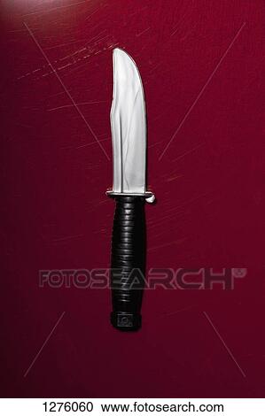 A hunting knife on a red background View Large Photo Image Stock Image - A hunting knife on a red background. Fotosearch
