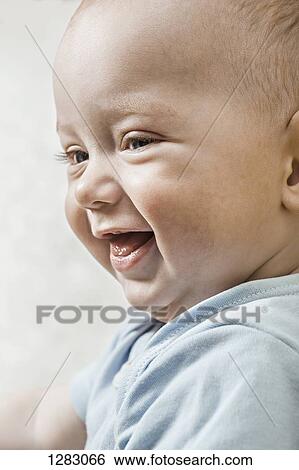 Stock Photograph - A laughing baby boy. Fotosearch