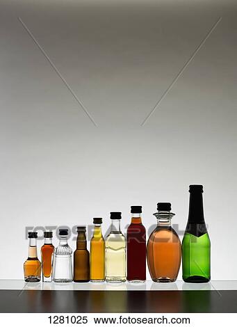 A line of various miniature bottles of alcohol without labels, back lit View Large Photo Image Stock Photography - A line of various miniature bottles of alcohol without labels, back lit. Fotosearch