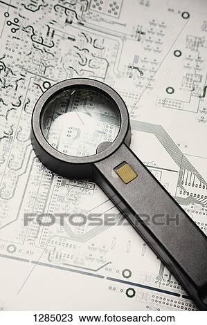 A magnifying glass lying on a schematic for a circuit board View Large Photo Image Stock Image - A magnifying glass lying on a schematic for a circuit board. Fotosearch