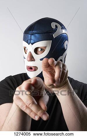 A man wearing a Lucha Libre wrestling mask and gesturing bizarrely with his hands View Large Photo Image Stock Photography - A man wearing a Lucha Libre wrestling mask and gesturing bizarrely with his hands. Fotosearch