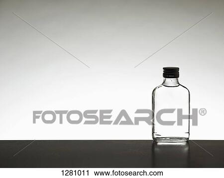 A miniature bottle of alcohol without a label, back lit View Large Photo Image Stock Image - A miniature bottle of alcohol without a label, back lit. Fotosearch