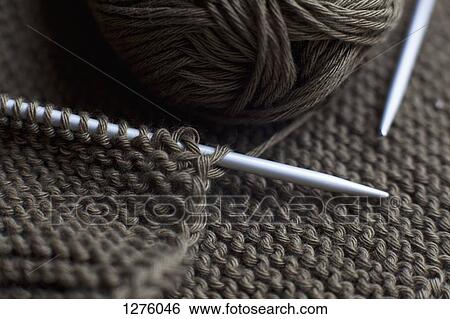 A pair of knitting needles, knitting and a ball of yarn, full frame View Large Photo Image Stock Photograph - A pair of knitting needles, knitting and a ball of yarn, full frame. Fotosearch