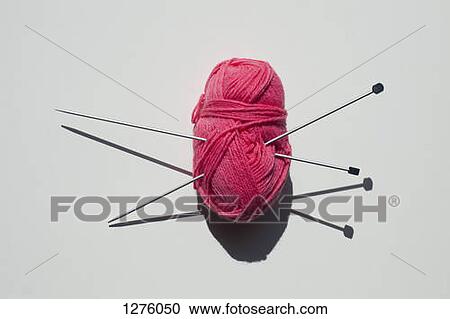 A pair of knitting needles stuck into a ball of yarn View Large Photo Image Stock Image - A pair of knitting needles stuck into a ball of yarn. Fotosearch