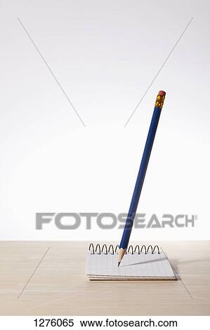 A pencil poised above a graph paper spiral notepad View Large Photo Image Stock Photography - A pencil poised above a graph paper spiral notepad. Fotosearch