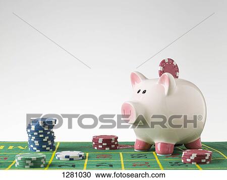 A piggy bank on a gambling table with stacks of gambling chips View Large Photo Image Stock Image - A piggy bank on a gambling table with stacks of gambling chips. Fotosearch