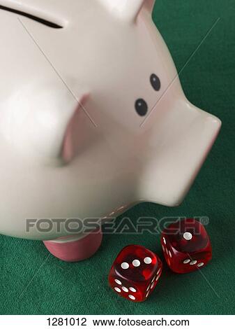A piggy bank with two red die next to it View Large Photo Image Stock Image - A piggy bank with two red die next to it. Fotosearch