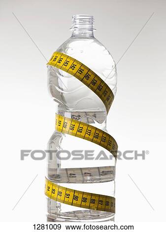 A plastic water bottle full of water and wrapped with a tape measure View Large Photo Image Stock Photo - A plastic water bottle full of water and wrapped with a tape measure. Fotosearch