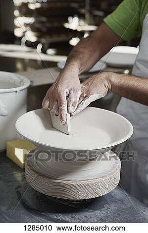 A potter molding a bowl on a potter's wheel View Large Photo Image Stock Image - A potter molding a bowl on a potter's wheel. Fotosearch