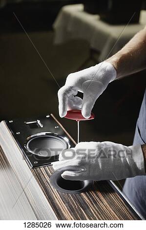 A repairman working an audio speaker View Large Photo Image Stock Photograph - A repairman working an audio speaker. Fotosearch