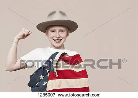 A smiling girl wearing a ranger hat wrapped in an American flag and making a fist View Large Photo Image Stock Photo - A smiling girl wearing a ranger hat wrapped in an American flag and making a fist. Fotosearch
