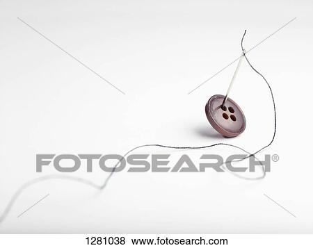 A threaded needle and button View Large Photo Image Stock Photo - A threaded needle and button. Fotosearch