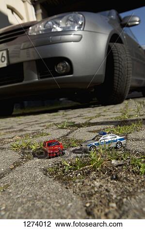 A toy car crash with a toy police car, real car in background View Large Photo Image Stock Image - A toy car crash with a toy police car, real car in background. Fotosearch