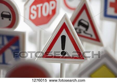 Stock Photography - A toy hazard sign surrounded by other various road warning signs. Fotosearch