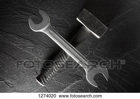 A wrench balancing on a club hammer lying on a granite countertop View Large Photo Image Stock Image - A wrench balancing on a club hammer lying on a granite countertop. Fotosearch