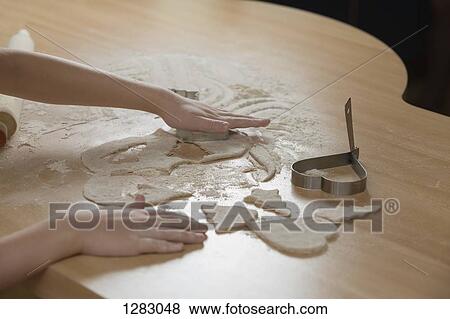 A young girl rolling out dough for cookies View Large Photo Image Stock Photo - A young girl rolling out dough for cookies. Fotosearch