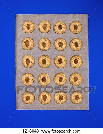 Almond biscuits on baking paper against blue background View Large Photo Image Stock Image - Almond biscuits on baking paper against blue background. Fotosearch