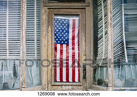 An American flag hanging in the door of a small business View Large Photo Image Stock Photo - An American flag hanging in the door of a small business. Fotosearch