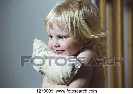 Blonde haired girl hugging pillow View Large Photo Image Stock Photography - Blonde haired girl hugging pillow. Fotosearch