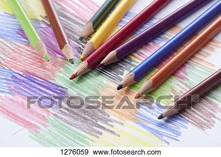 Colored pencils lying on a drawing with colored scribbles View Large Photo Image Stock Photo - Colored pencils lying on a drawing with colored scribbles. Fotosearch