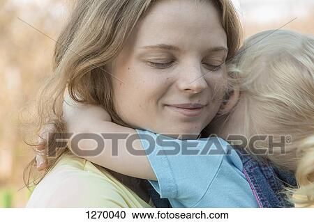 Stock Image - Daughter hugging mother. Fotosearch