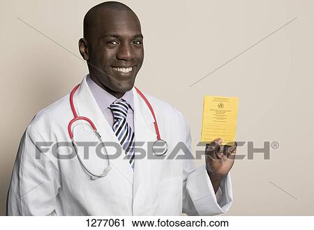Doctor wearing stethoscope holding German Immunisation Certificate View Large Photo Image Stock Image - Doctor wearing stethoscope holding German Immunisation Certificate. Fotosearch
