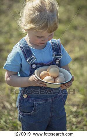 Farmer girl holding bowl of eggs View Large Photo Image Stock Photo - Farmer girl holding bowl of eggs. Fotosearch