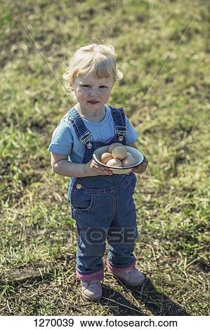 Farmer girl holding bowl of eggs View Large Photo Image Stock Photo - Farmer girl holding bowl of eggs. Fotosearch