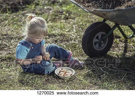 Stock Photography - Farmer girl holding eggs. Fotosearch