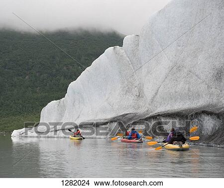 Five kayakers paddling at Valdez Glacier, Alaska, USA View Large Photo Image Picture - Five kayakers paddling at Valdez Glacier, Alaska, USA. Fotosearch