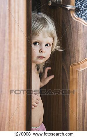 Girl standing by open door View Large Photo Image Stock Photo - Girl standing by open door. Fotosearch