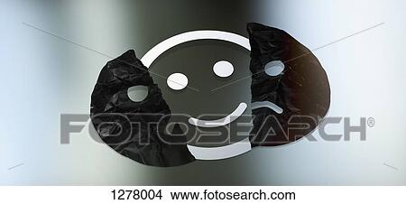 Graphic of a smiley face behind a torn sad face View Large Photo Image Picture - Graphic of a smiley face behind a torn sad face. Fotosearch